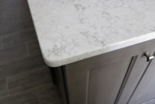 Light counters, gray cabinets, driftwood ceramic floor